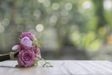 Artificial  roses on a wooden floor,bokeh background.