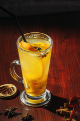 Winter healing ginger drink with honey and oranges. Cinnamon, star anise, fir twigs, tangerines, dried grapefruit.