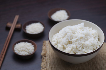 Thai rice with chopsticks on wood background