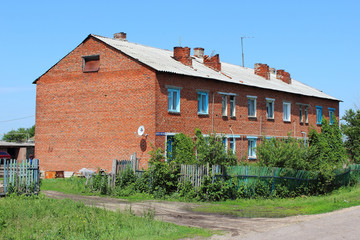 Fototapeta na wymiar two-storey brick house in the countryside in the summer