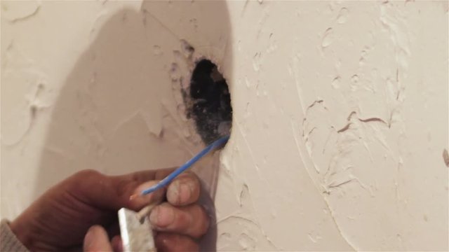  remove the wire insulation socket/man removes insulation from electrical wire socket