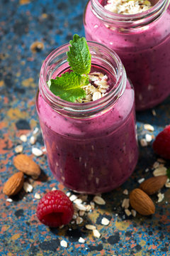 berry smoothie in a bottle on a dark background, top view