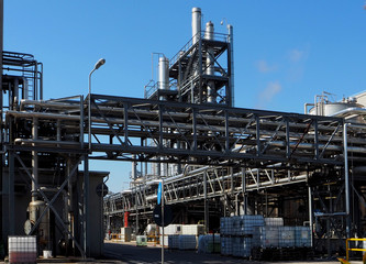 Fototapeta na wymiar Industrial plant with tubes and smoke stack