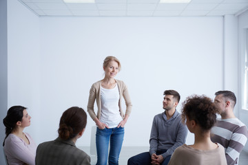 Fototapeta na wymiar Woman talking during group therapy
