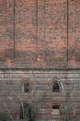 Outside wall of an abandoned brick building in an industrial area  like a post apocalyptic  scene