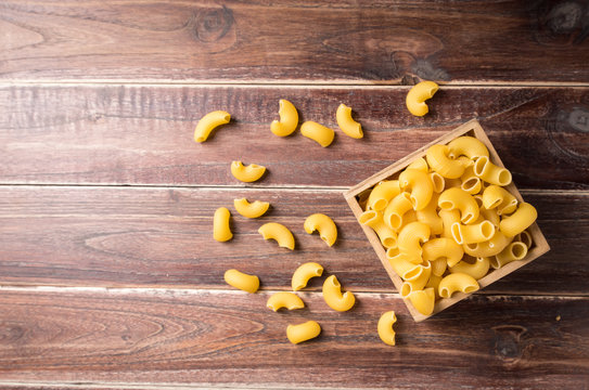 Raw macaroni on wooden background,Top view