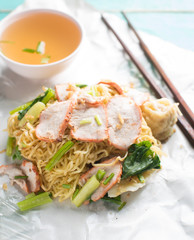 Egg noodle and soup on blue wood