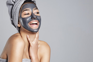 laughing woman having fun with facial mask on - 140493626
