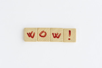 The word  "wow" formed with small wooden dowels