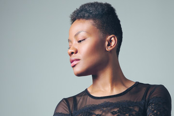 profile portrait of black woman with ideal skin and short haircut