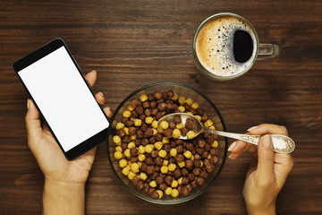 Having a breakfast with cell phone in the hand