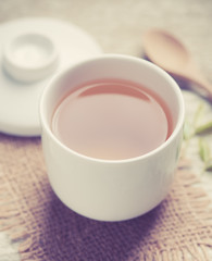 Cup of tea and tea leaves on wooden ; vintage tone style
