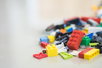 Background of random coloured plastic construction blocks or brick toy. Concept of education,...