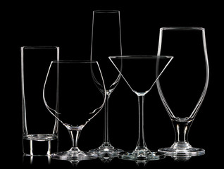 Silhouette of different glasses on black background.