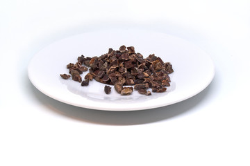 cacao nibs on a plate isolated
