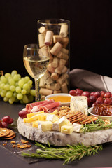 A plate of cheese with white wine