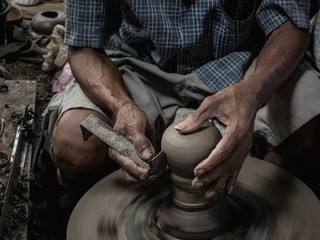 Master are molding clay to make earthenware