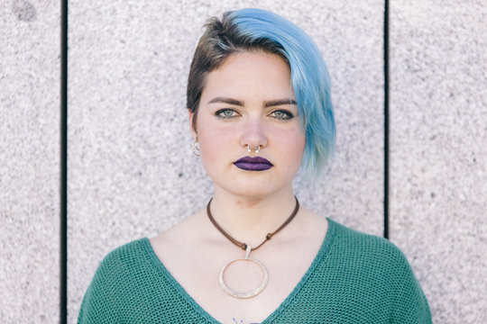 Portrait of a teen with blue hair and nose piercing