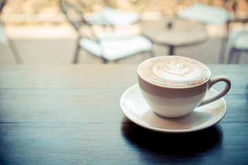 cup of coffee on wooden counter in cafe