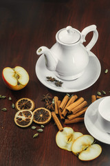 Tea cups with teapot on old wooden table