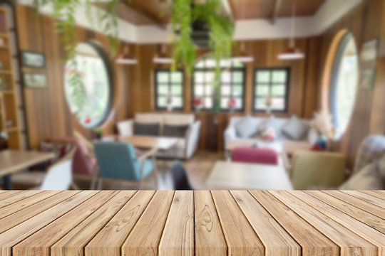 wooden table with blurred of coffee shop background