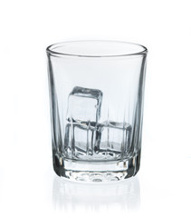 Glass with ice cubes isolated on white background