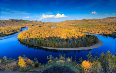 Bairu Island in the middle of winding river, color of autumn in northeast China
