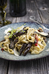 Traditional Italian Pappardelle alla Melanzane as close-up on a Plate