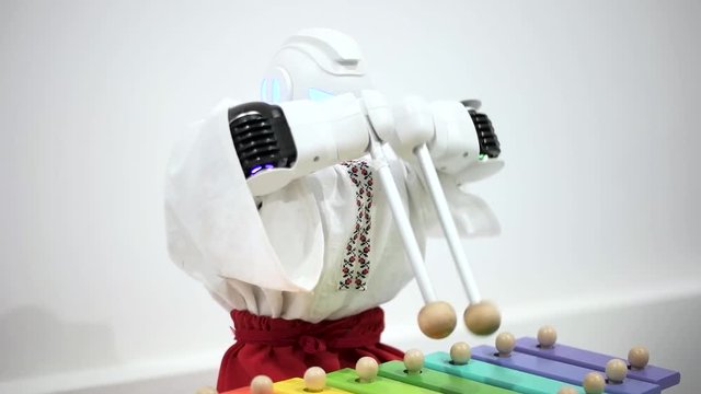 Robot plays on xylophone close up.