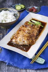Traditional Japanese Fish Teriyaki with Rice as close-up on a plate