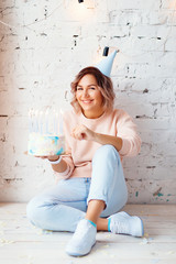 Beautiful happy woman her birthday. Girl with cake. Celebrating concept