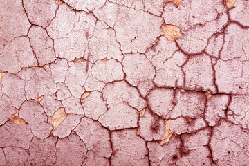 Cracked red cement wall texture.