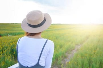 Woman stands at Flower Crotalaria yellow.