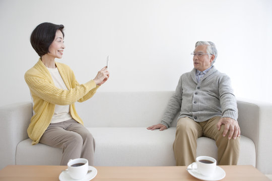 Senior couple taking photo with smartphone