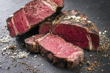 Barbecue dry aged Wagyu Rib Eye Steak as close-up on a slate