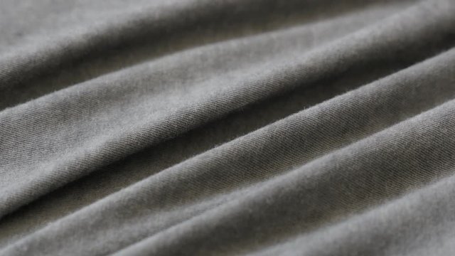 Fine silky cotton of grey smoked color t-shirt 2160p 30fps UltraHD tilting footage - High quality shiny gray modern fabric slow tilt 4K 3840X2160 UHD video 