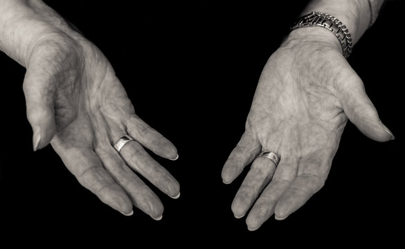Black and white image of older lady's empty hands,