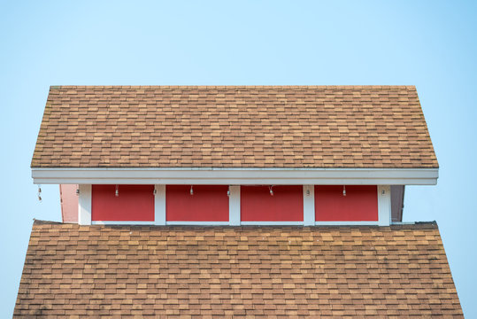 The rubber roof tiles with red wall of house