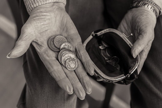 British coins in the hand of a pensioner.