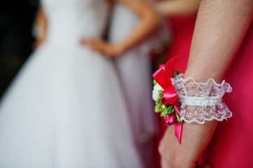 Small bouquet on hand of bridesmaid at rose dress on wedding day.