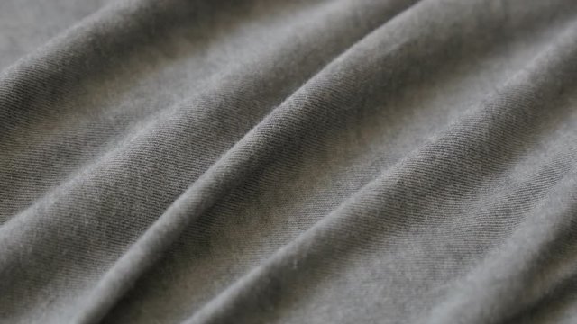 Fine silky cotton of grey smoked color t-shirt 2160p 30fps UltraHD tilting footage - High quality shiny gray modern fabric slow tilt 4K 3840X2160 UHD video 
