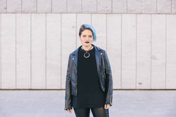 young punk woman with blue dyed hair and a leather jacket