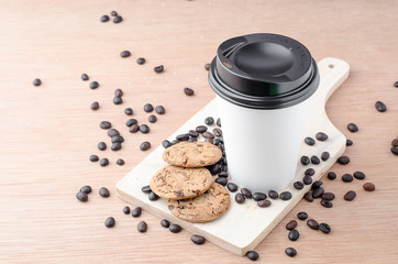 Coffee cup and coffee beans on wooden background