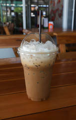 Iced coffee on wooden table 