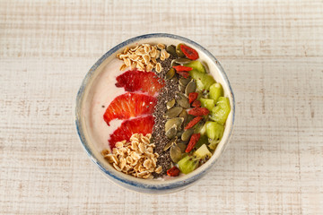 Superfoods smoothies bowl with chia seeds, oats, goji berry and fruit. Overhead, top view, flat lay.