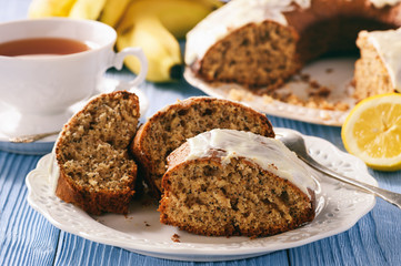 Banana cake with poppy seeds on wooden table.