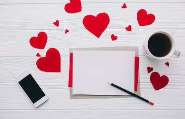 valentines day love letter on white wooden background with smart phone  and presents