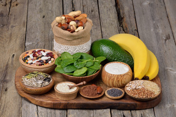 Healthy food, products containing magnesium on wooden background.