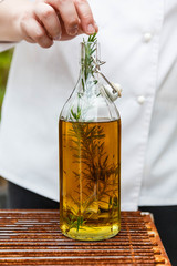 Chef Put Fresh Rosemary in Olive, Rosemary Oil in The Glass Bottle.