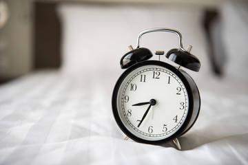 alarm clock on bed